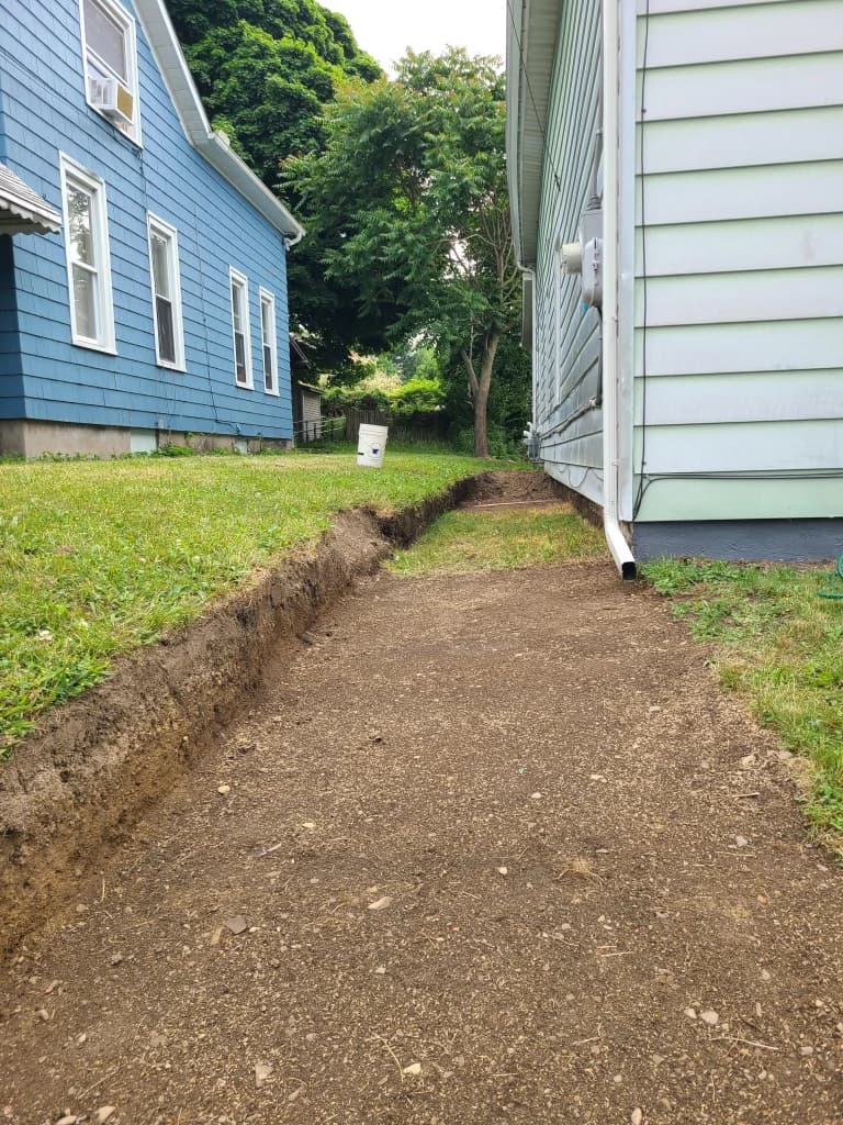 Grading 101: what positive drainage actually looks like.