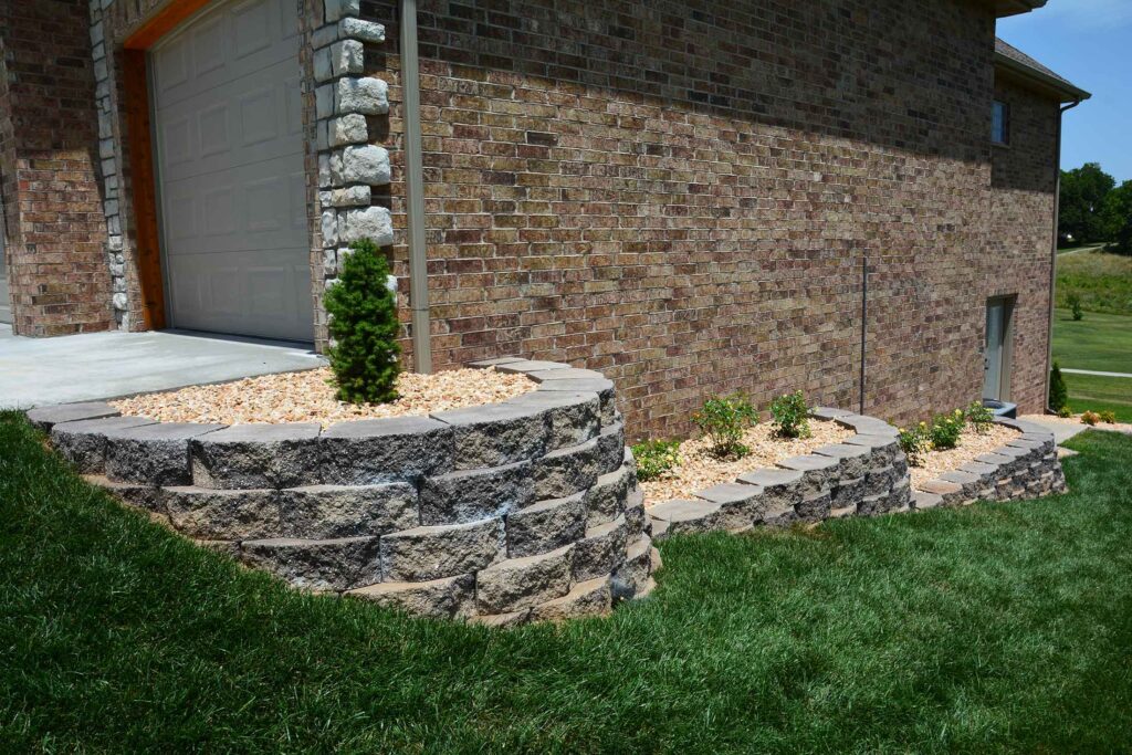 Foundation wall and front-yard rock bed